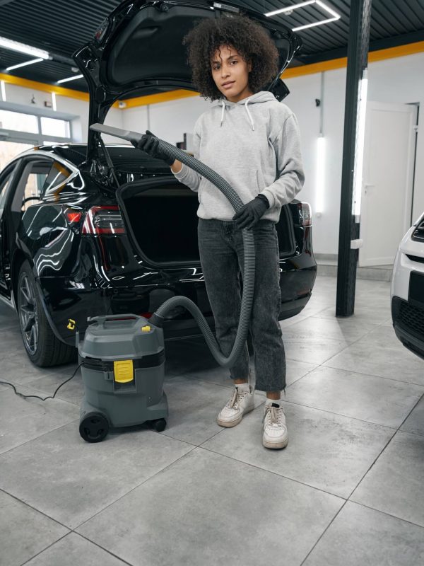auto-detailer-standing-beside-motor-vehicle-with-open-trunk.jpg
