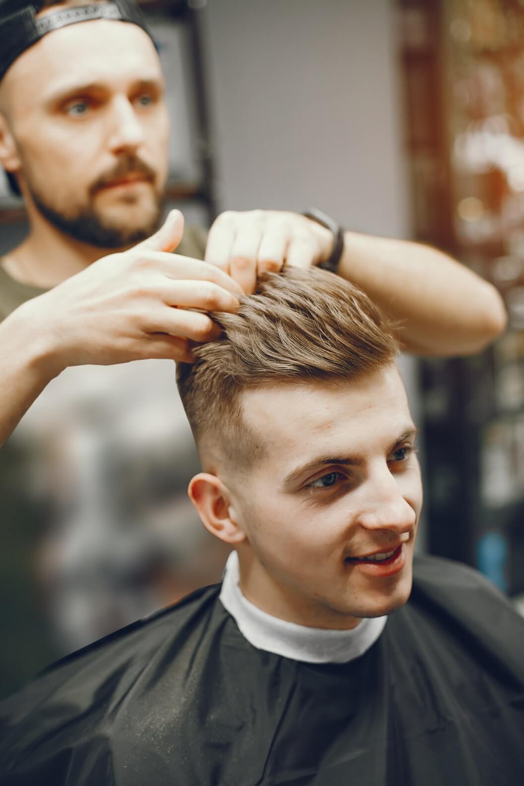 a-man-cuts-hair-in-a-barbershop-726GRFT.jpg